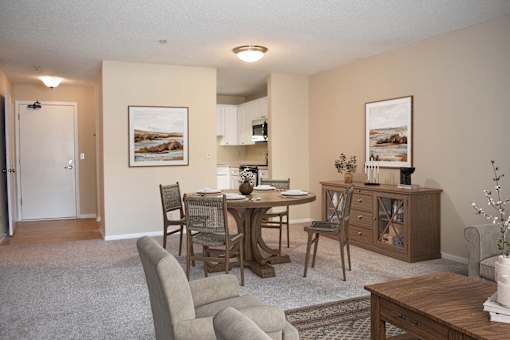 A dining room with a table set for four.