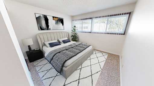 a bedroom with a bed and a large window