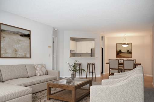 A living room with a couch, chairs, and a coffee table.