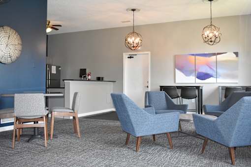 A modern living room with grey and blue chairs.