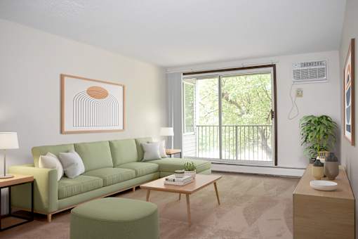 A living room with a green couch, a coffee table, and a painting on the wall.