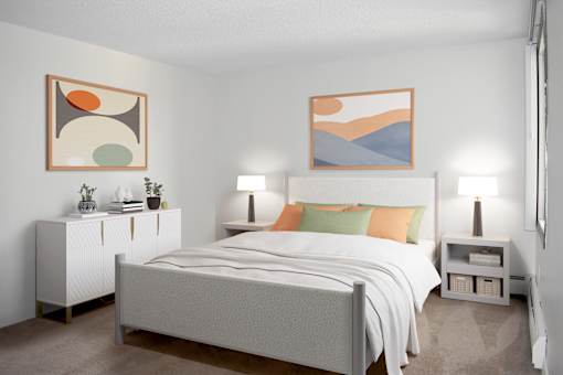 A bedroom with a bed, nightstands, and two framed artworks on the wall.