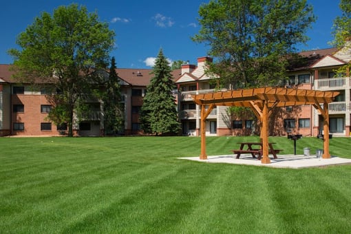 Large manicured lawn with a sun terrace over a park bench