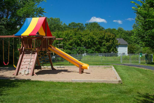 Jungle gym / rainbow playset in an enclosure of sand outdoors