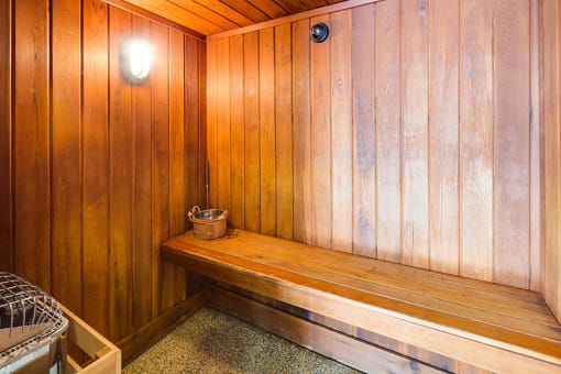 Wood panneled sauna with a bench