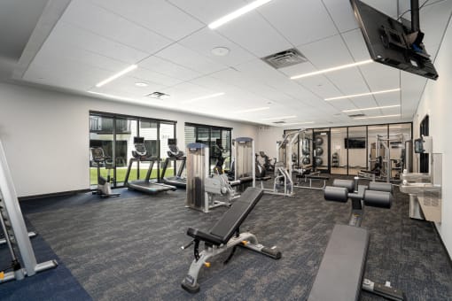 Fitness center with a variety of equipment and large windows