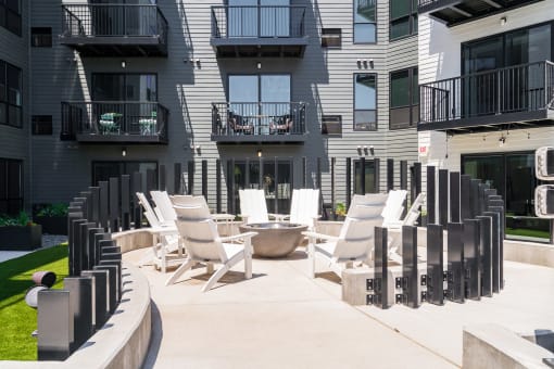 Outdoor fireplace surrounded by chairs