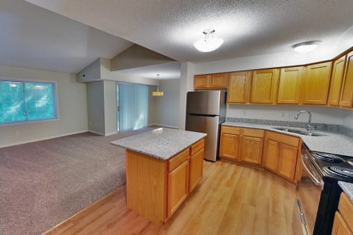 a kitchen with wooden cabinets and stainless steel appliances