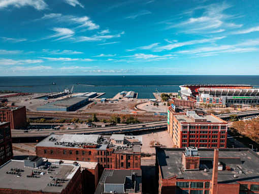 A view of a cityscape with a large body of water in the background.