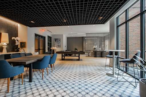 A dining room with a long table and chairs.