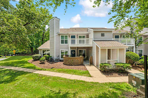 A house with a well-maintained lawn and a clear sky.