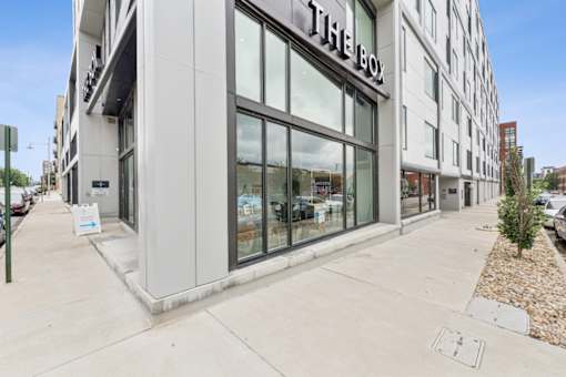 The box storefront is white and has a black awning at The Box, Richmond, VA, 23224