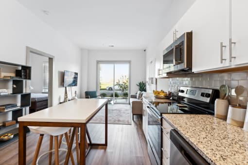 a kitchen and dining area in a 555 waverly unit  at The Point on 38th, Norfolk, Virginia