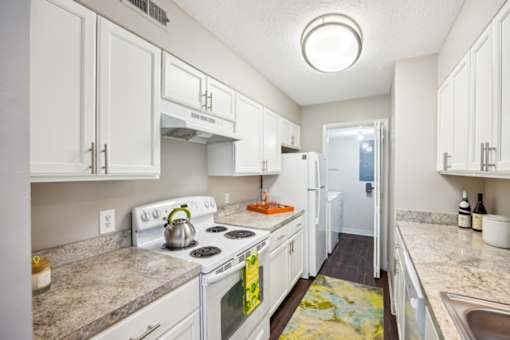 A kitchen with white cabinets and a stove top oven at Chinoe Creek Apartments, Lexington 40502