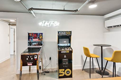 A room with two Atari 500 arcade machines and a table with two chairs at The Box, Richmond, VA, 23224