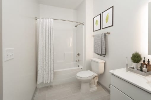 a white bathroom with a shower and a toilet at The Waterford At Rocketts Landing Apartments, PRG Real Estate, Richmond, Virginia