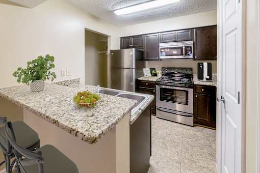 Kitchen with granite countertops and stainless steel appliances at Herons Point, Virginia Beach, 23451