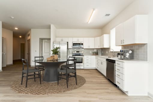 a kitchen and dining area in a 555 waverly unit at The Waterford At Rocketts Landing Apartments, PRG Real Estate, Richmond, Virginia