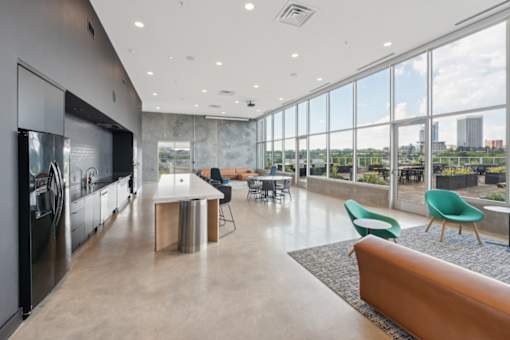 A modern kitchen with a view of the city at South Falls Tower Apartments, Richmond, Virginia