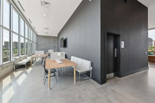 A modern room with a long table and chairs at South Falls Tower Apartments, Richmond 23224