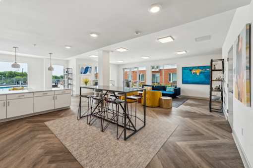 A modern living room with a dining table and chairs  at The Waterford At Rocketts Landing Apartments, PRG Real Estate, Richmond, Virginia