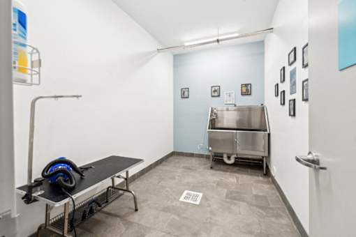 A room with a table, a bench, and a machine at The Point Apartments on 38th, Norfolk, Virginia