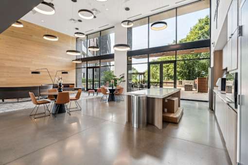 A modern kitchen with a dining table and chairs.