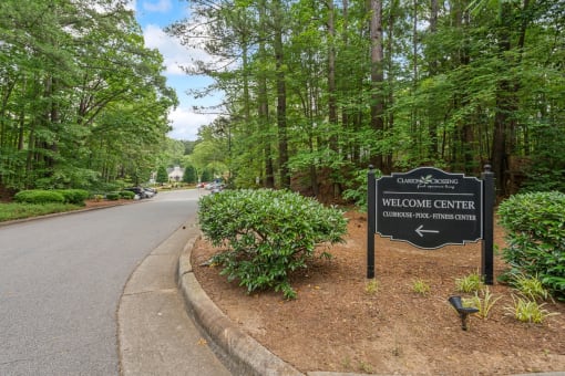 a sign for the welcome center on the side of a road at Clarion Crossing Apartments, PRG Real Estate Management, Raleigh