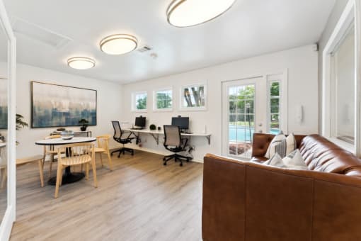 a living room with a couch and a table with chairs  at Willow Ridge Apartments, Charlotte, North Carolina