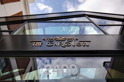 The Carousel building has a glass window with the number 2400 on it at The Carousel Apartments, Virginia, 23220