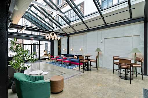 A room with a glass ceiling and a green chair at The Carousel Apartments, Richmond
