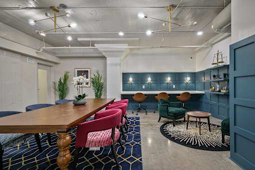 A conference room with a long table and chairs at The Carousel Apartments, Virginia