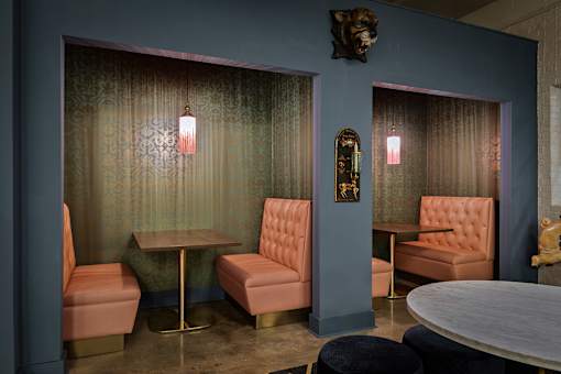 A room with a table, chairs and a wall decoration at The Carousel Apartments, Richmond, VA
