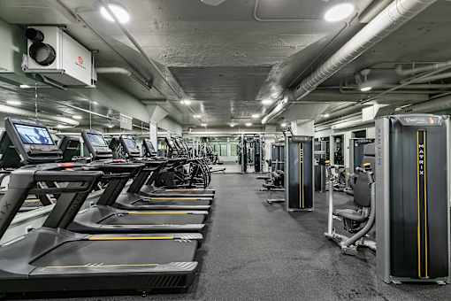 A gym with treadmills and exercise equipment at The Carousel Apartments, Virginia