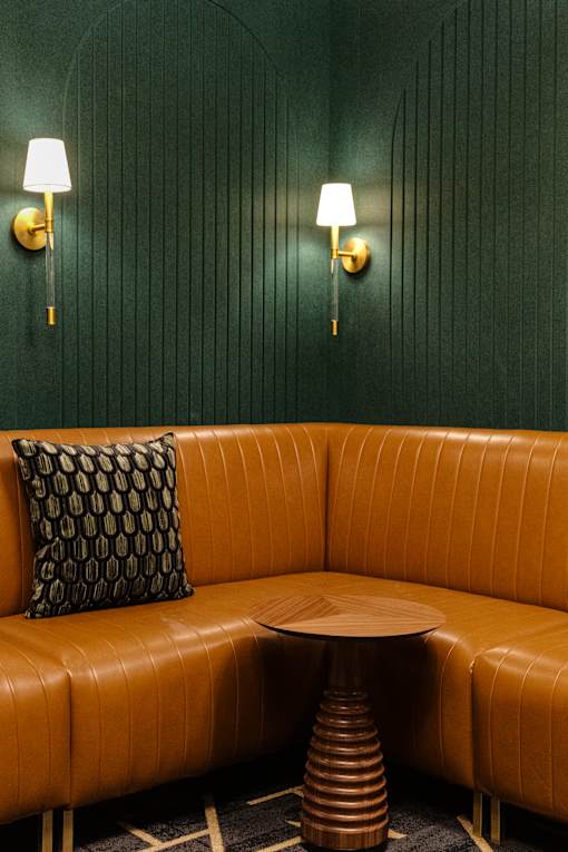 A brown leather couch with a round table in front of it at The Carousel Apartments, Virginia, 23220