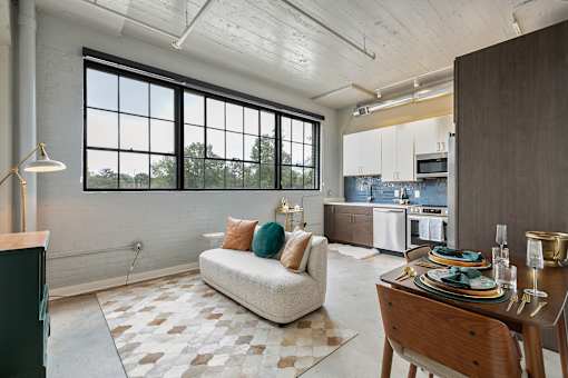 A modern kitchen with a dining table set for two at The Carousel Apartments, Richmond, Virginia