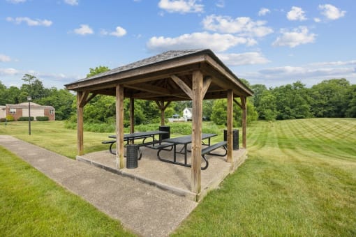 a pavilion with a picnic table in a park at The Grove at Lyndon, Louisville