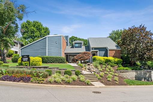 A house with a green lawn and a sign at Woodcreek Apartments, Cary, North Carolina