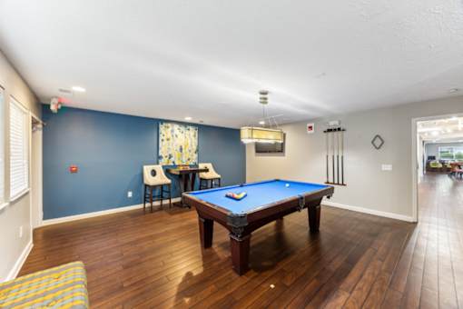 A pool table in a room with blue walls at Chinoe Creek Apartments, Lexington, KY, 40502