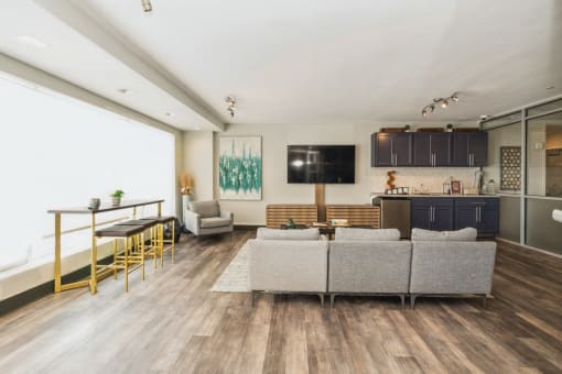 a living room with a couch and a table and a kitchen at The Lafayette Apartments, Colonial Place, Norfolk