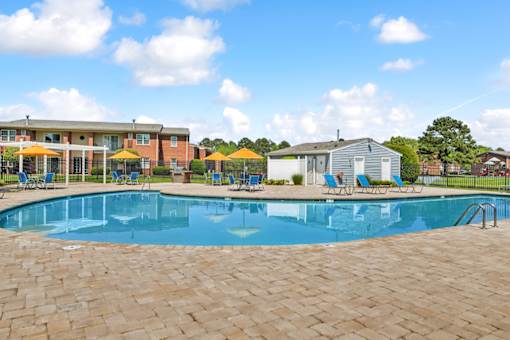 A large swimming pool surrounded by a brick patio. at Rivers Landing Apartments, Hampton 23666