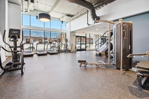 a gym with cardio equipment and windows in a building  at The Box, Virginia