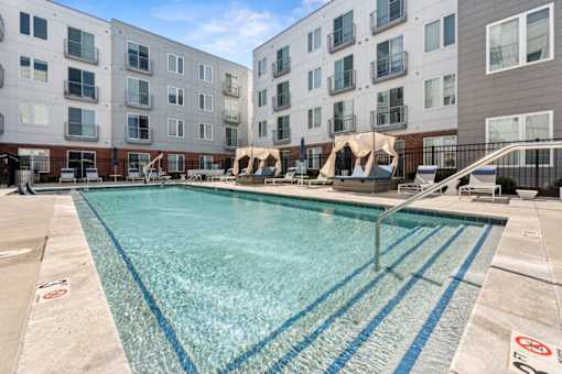 A swimming pool in front of apartment buildings at The Point Apartments on 38th, Norfolk, Virginia