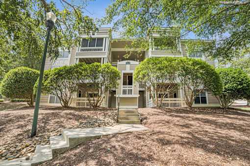A house with a front yard and a tree in front of it at Beacon Ridge Apartments, PRG Real Estate Management, Greenville, 29615
