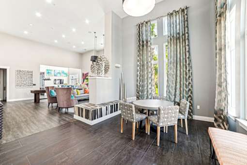 A modern dining room with a glass table and chairs at Proximity Apartments, South Carolina, 29414