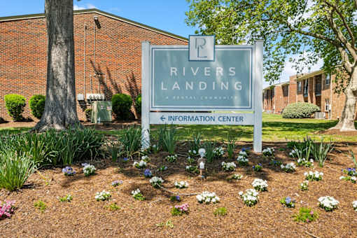 A sign for Rivers Landing is in front of a building at Rivers Landing Apartments, Virginia