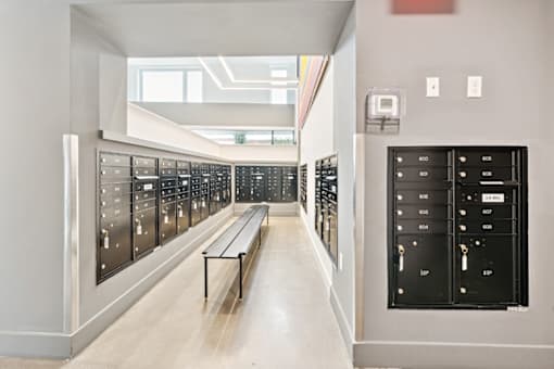 A long hallway with a bench and a row of lockers on the side at The Box, Richmond, VA, 23224