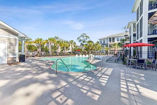 A pool area with a small pool and sun loungers at Proximity Apartments, South Carolina, 29414