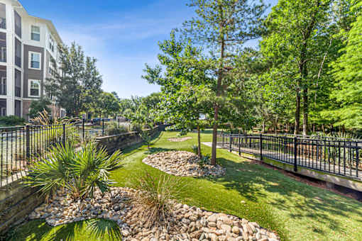 A well-maintained garden with a small stream running through it at Proximity Apartments, South Carolina, 29414