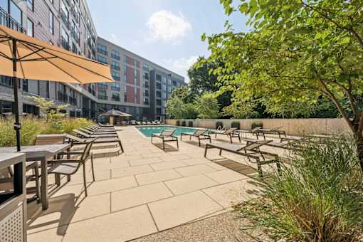 A sunny day at the outdoor pool area of a residential building.